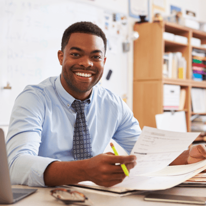 Male Teacher Sitting at Desk