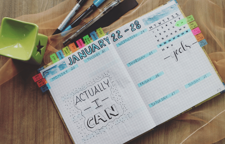 day planner with colorful highlights laying on a table