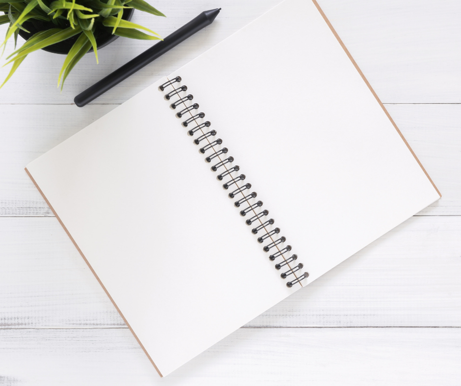 blank notebook and pens on a table