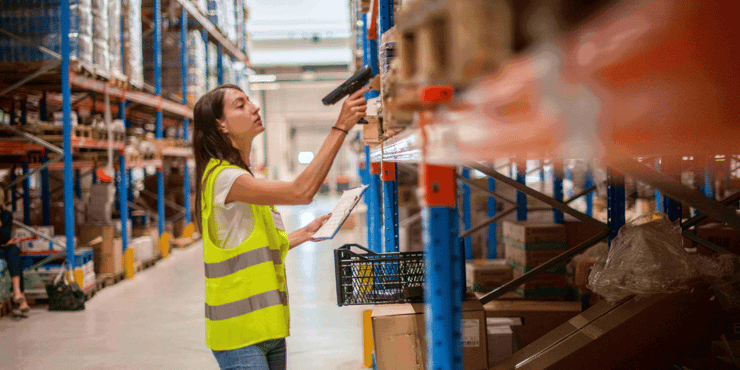 Female Worker in warehouse review the goods