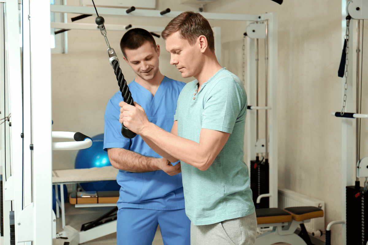 Rehab and Sports science - Man with physician in rehab