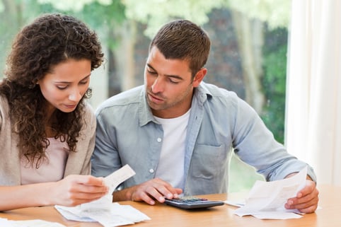 Young couple calculating their domestic bills at home